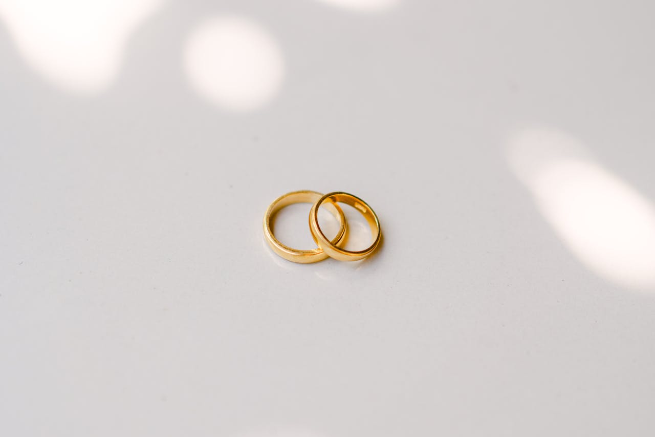 elegant-gold-wedding-rings-on-minimalist-surface-32266896